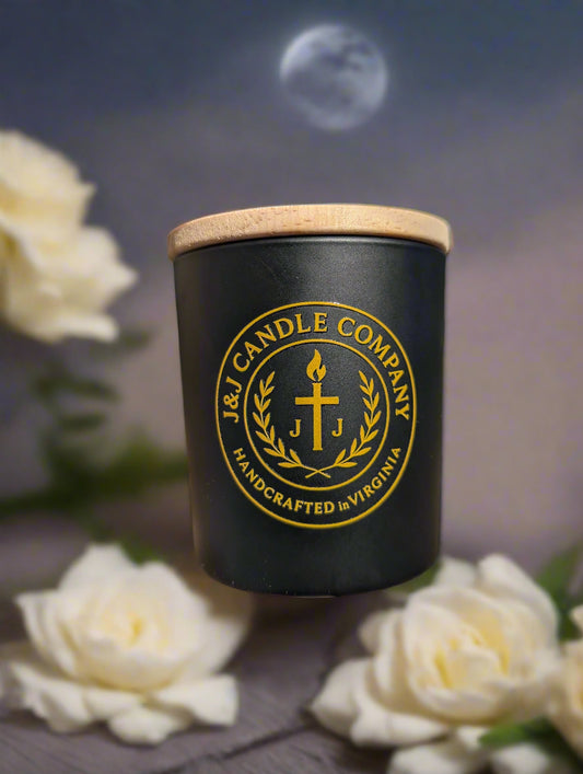 Black candle with a wooden lid featuring the J&J Candle Company logo