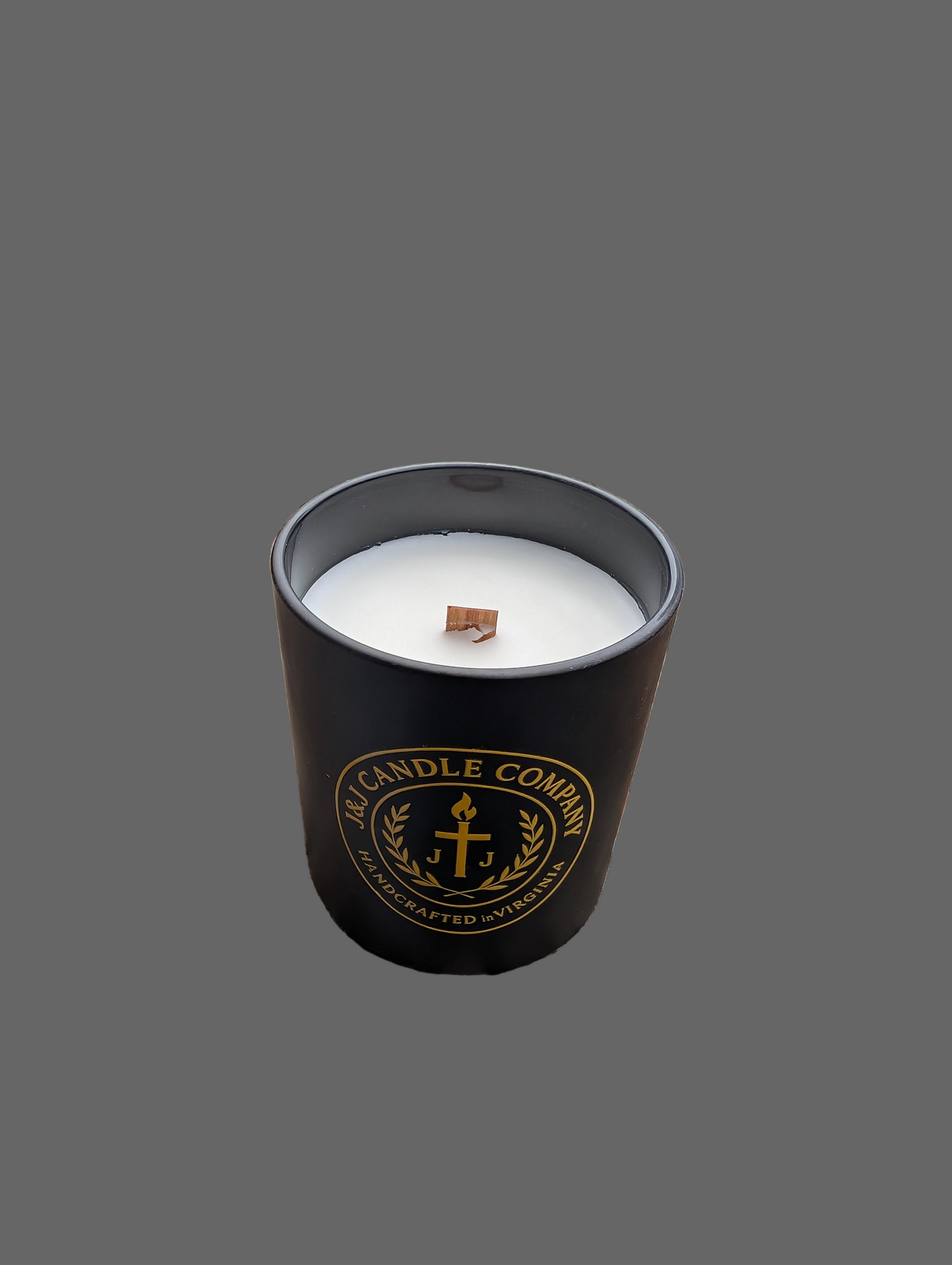 Candle in a black container with 'The Candle Company